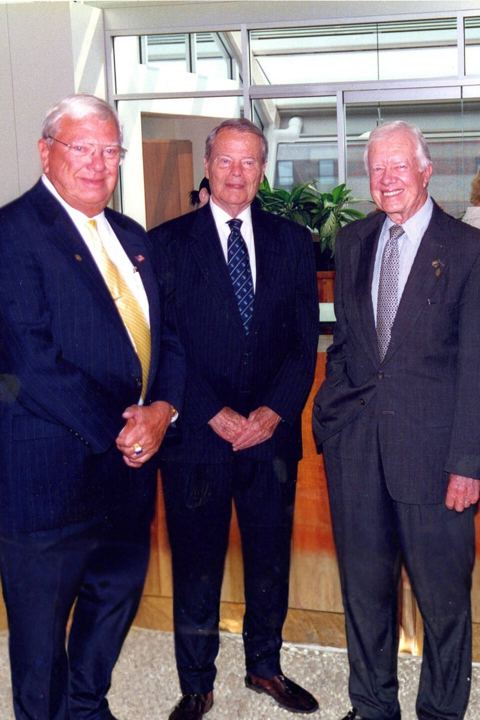 Ralph Hauenstein, Peter Cook, and Presdent Jimmy Carter pose for a photo.